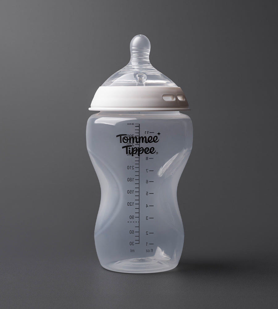 Tommee Tippee baby bottle on a dark gray background
